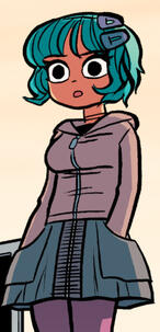 Ramona wearing a muted pink jacket, a denim skirt with pockets and purple leggings